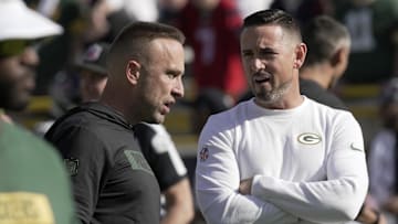 Oct 20, 2024; Green Bay, Wisconsin, USA; Green Bay Packers defensive coordinator Jeff Hafley, left, talks with head coach Matt LaFleur before their game against the Houston Texans at Lambeau Field. Mandatory Credit: Mark Hoffman/USA TODAY Network via Imagn Images