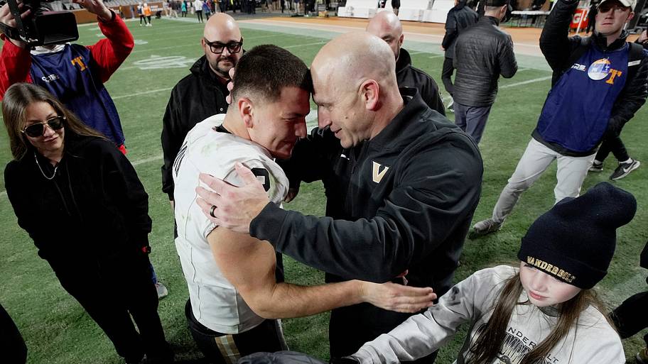 Diego Pavia and coach Clark Lea embrace.