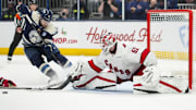 Nov 23, 2024; Columbus, Ohio, USA;  Carolina Hurricanes goaltender Pyotr Kochetkov (52) makes a save in net against Columbus Blue Jackets defenseman Ivan Provorov (9) in the overtime period at Nationwide Arena. Mandatory Credit: Aaron Doster-Imagn Images