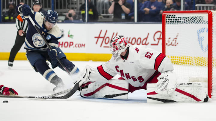 Nov 23, 2024; Columbus, Ohio, USA;  Carolina Hurricanes goaltender Pyotr Kochetkov (52) makes a save in net against Columbus Blue Jackets defenseman Ivan Provorov (9) in the overtime period at Nationwide Arena. Mandatory Credit: Aaron Doster-Imagn Images