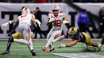 Jan 20, 2025; Atlanta, GA, USA; Ohio State Buckeyes running back TreVeyon Henderson (32) runs with the ball against the Notre Dame Fighting Irish during the first half the CFP National Championship college football game at Mercedes-Benz Stadium. Mandatory Credit: Brett Davis-Imagn Images