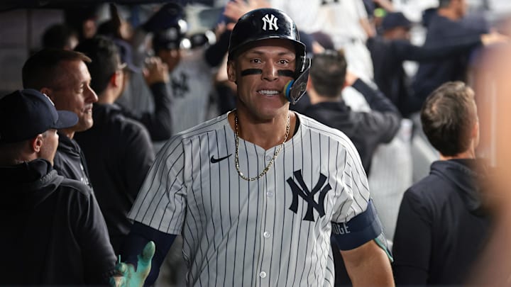 Sep 13, 2024; Bronx, New York, USA; New York Yankees center fielder Aaron Judge (99) celebrates in the dug out after hitting a grand slam home run during the seventh inning against the Boston Red Sox at Yankee Stadium. Mandatory Credit: Vincent Carchietta-Imagn Images