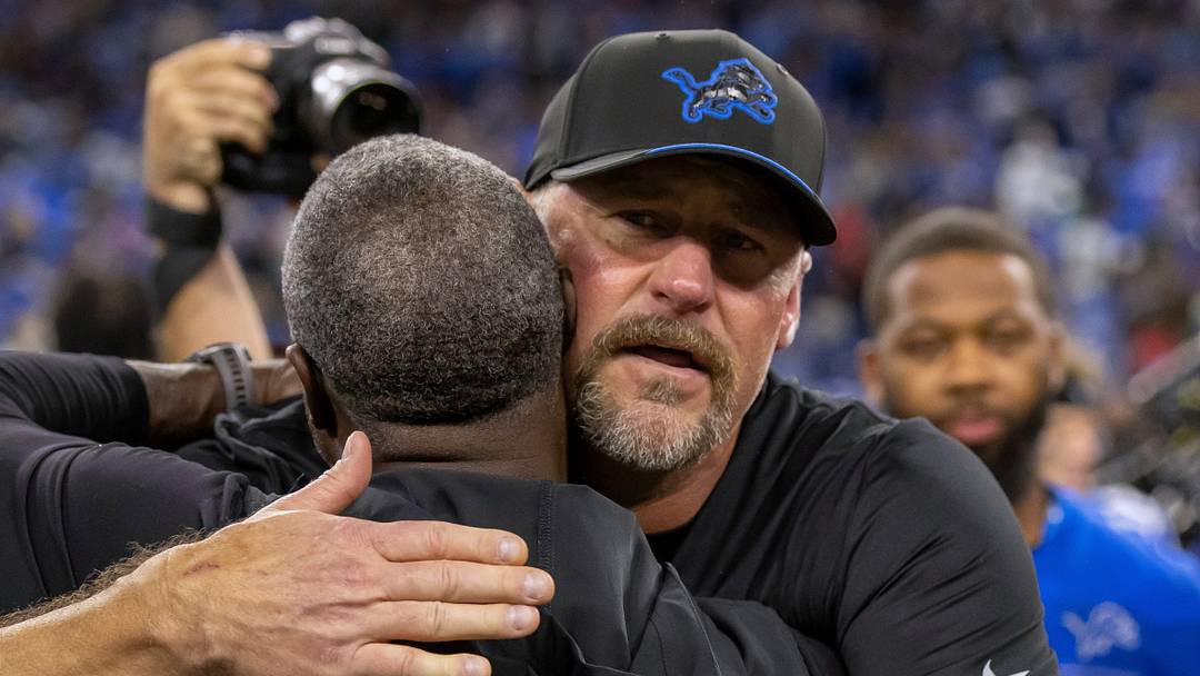 New York Jets head coach Aaron Glenn hugs Detroit Lions head coach Dan Campbell.