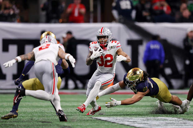 Ohio State Buckeyes running back TreVeyon Henderson runs with the ball against the Notre Dame Fighting Irish