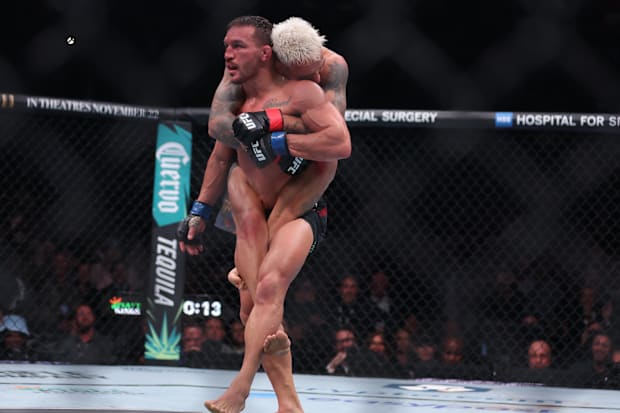 Charles Oliveira (red gloves) fights Michael Chandler (blue gloves) in the lightweight bout during UFC 309.