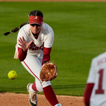 Feb 21, 2025; Tuscaloosa, Alabama, USA; Alabama second baseman Kali Heivilin snags a grounder and throws to first baseman Abby Duchscherer for an out against Virginia Tech during the Easton Bama Bash at Rhoads Stadium Friday in the home opener for the Crimson Tide.