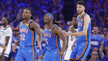 May 22, 2025; Oklahoma City, Oklahoma, USA; Oklahoma City Thunder guard Luguentz Dort (5) celebrates with guard Cason Wallace (22) and forward Chet Holmgren (7) after a play against the Minnesota Timberwolves in the third quarter during game two of the western conference finals for the 2025 NBA Playoffs at Paycom Center. Mandatory Credit: Alonzo Adams-Imagn Images
