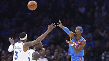 Dec 31, 2024; Oklahoma City, Oklahoma, USA; Oklahoma City Thunder guard Shai Gilgeous-Alexander (2) passes over Minnesota Timberwolves forward Jaden McDaniels (3) during the second quarter at Paycom Center. Mandatory Credit: Alonzo Adams-Imagn Images