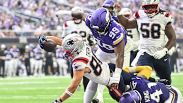Aug 16, 2025; Minneapolis, Minnesota, USA;  New England Patriots wide receiver Efton Chism III (86) scores a touchdown as Minnesota Vikings linebacker Kobe King (41) and defensive end Alex Williams (99) attempt to make the stop during the second quarter at U.S. Bank Stadium. Mandatory Credit: Jeffrey Becker-Imagn Images