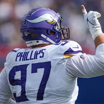 Sep 8, 2024; East Rutherford, New Jersey, USA; Minnesota Vikings defensive tackle Harrison Phillips (97) celebrates a defense stop during the second half against the New York Giants at MetLife Stadium. Mandatory Credit: Vincent Carchietta-Imagn Images