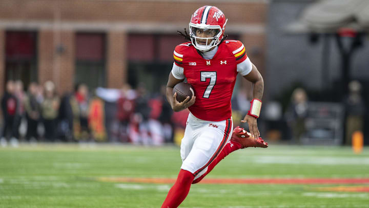 Nov 22, 2025; College Park, Maryland, USA;  Maryland Terrapins quarterback Malik Washington (7) scrambles during the first quarter against the Michigan Wolverines at SECU Stadium. Mandatory Credit: Tommy Gilligan-Imagn Images