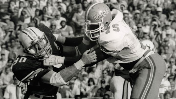 Oct 1, 1984; Unknown location, USA,FILE PHOTO; Auburn tigers defensive tackle Kevin Greene (90) in action against the Florida Gators tackle Lomas Brown Jr. Mandatory Credit: Malcolm Emmons-Imagn Images