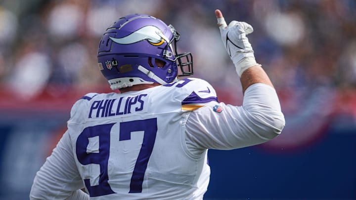 Sep 8, 2024; East Rutherford, New Jersey, USA; Minnesota Vikings defensive tackle Harrison Phillips (97) celebrates a defense stop during the second half against the New York Giants at MetLife Stadium. Mandatory Credit: Vincent Carchietta-Imagn Images