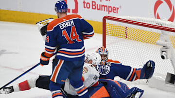 Jun 6, 2025; Edmonton, Alberta, CAN; Edmonton Oilers defenseman Mattias Ekholm (14) and goaltender Stuart Skinner (74) knock down Florida Panthers center Sam Bennett (9) during the first period in game two of the 2025 Stanley Cup Final at Rogers Place. Mandatory Credit: Walter Tychnowicz-Imagn Images