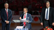 Washington Capitals owner Ted Leonsis speaks as general manager Brian MacLellan (left) and team president Dick Patrick (right) listen during a championship banner raising ceremony at Capital One Arena.