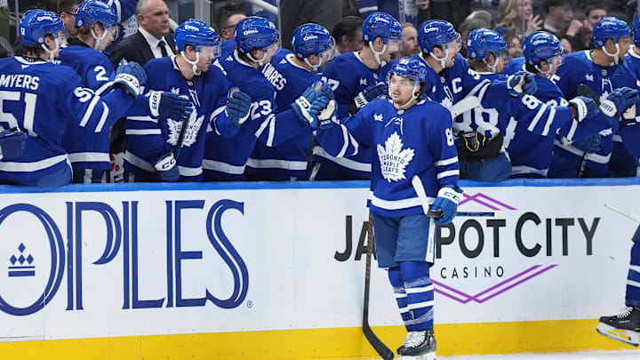 Dec 15, 2024; Toronto, Ontario, CAN; Toronto Maple Leafs left wing Nicholas Robertson (89) celebrates at the bench after scoring a goal against the Buffalo Sabres during the second period at Scotiabank Arena. Mandatory Credit: Nick Turchiaro-Imagn Images