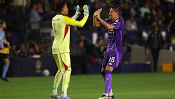 Mar 29, 2025; Carson, California, USA;  Orlando City goalkeeper Pedro Gallese (1) and defender Rodrigo Schlegel (15) celebrate a win after defeating the LA Galaxy at Dignity Health Sports Park. Mandatory Credit: Kiyoshi Mio-Imagn Images
