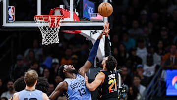 Dec 31, 2024; Phoenix, Arizona, USA; Phoenix Suns guard Tyus Jones (21) makes a lay up while Memphis Grizzlies forward-center Jaren Jackson Jr. (13) attempts to block him during the second quarter at Footprint Center. Mandatory Credit: Aryanna Frank-Imagn Images