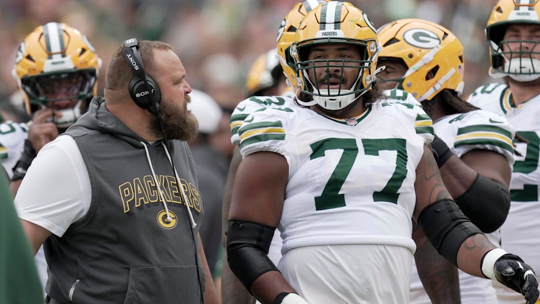 Green Bay Packers offensive tackle Jordan Morgan (77) listens to offensive line coach Luke Butkus during the first quarter of their preseason game Saturday, August 23, 2025 at Lambeau Field in Green Bay, Wisconsin. The Green Bay Packers beat the Seattle Seahawks 20-7.