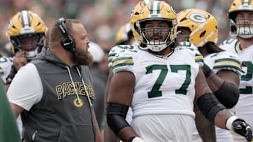 Green Bay Packers offensive tackle Jordan Morgan (77) listens to offensive line coach Luke Butkus during the first quarter of their preseason game Saturday, August 23, 2025 at Lambeau Field in Green Bay, Wisconsin. The Green Bay Packers beat the Seattle Seahawks 20-7.