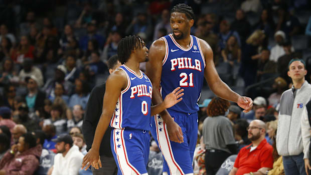 Philadelphia 76ers guard Tyrese Maxey (0) and center Joel Embiid (21) exchange words during a 2023-24 game against Memphis.