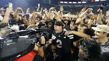 Sep 6, 2025; Starkville, Mississippi, USA; Mississippi State Bulldogs fans crowd around quarterback Blake Shapen (2) after defeating the Arizona State Sun Devilsat Davis Wade Stadium at Scott Field. Mandatory Credit: Petre Thomas-Imagn Images