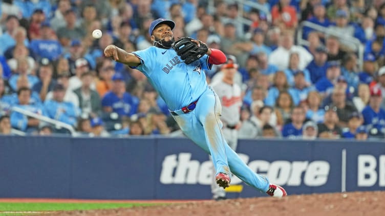 Aug 7, 2024; Toronto, Ontario, CAN; Toronto Blue Jays third baseman Vladimir Guerrero Jr. (27) throws a ball to first base against the Baltimore Orioles during the seventh inning at Rogers Centre. Mandatory Credit: Nick Turchiaro-USA TODAY Sports