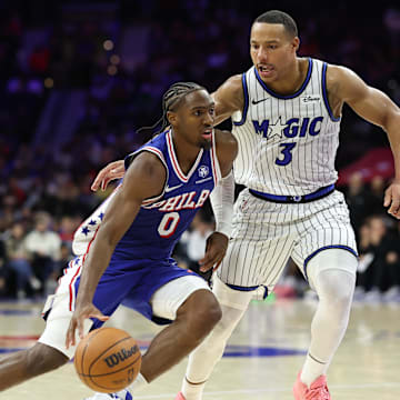 Oct 27, 2025; Philadelphia, Pennsylvania, USA; Philadelphia 76ers guard Tyrese Maxey (0) dribbles past Orlando Magic guard Desmond Bane (3) during the fourth quarter at Xfinity Mobile Arena. Mandatory Credit: Bill Streicher-Imagn Images