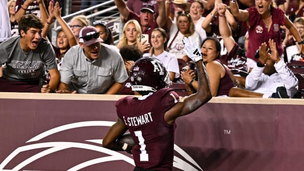 Texas A&M fans celebrate a touchdown with a player at Kyle Field