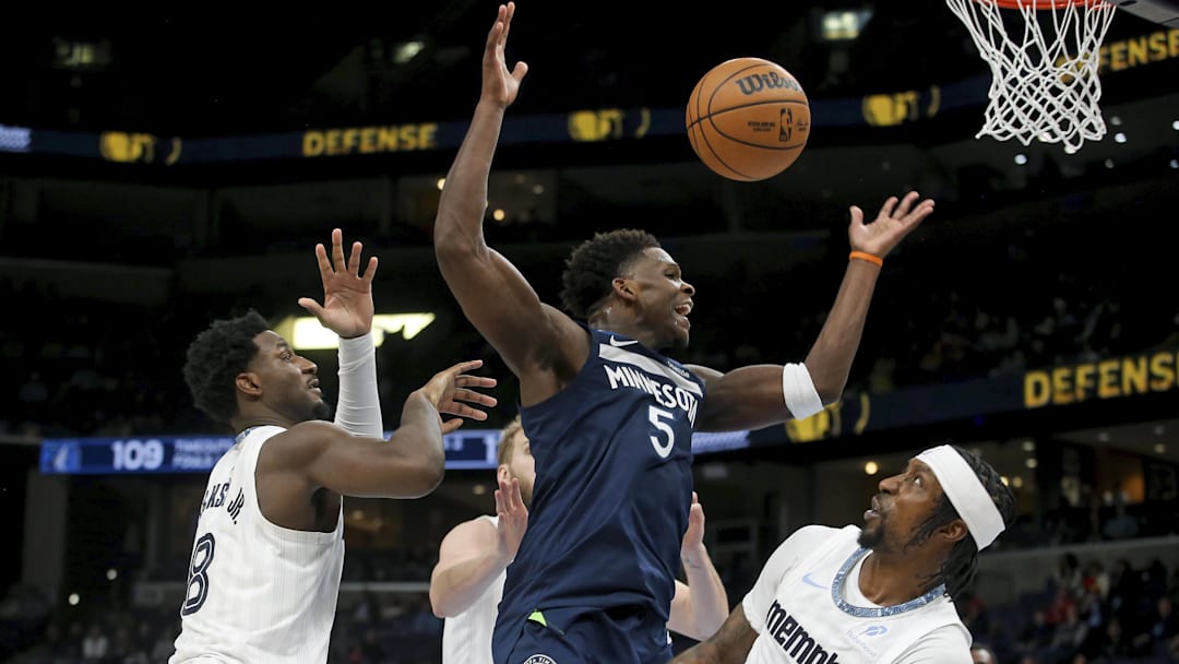 Feb 2, 2026; Memphis, Tennessee, USA; Minnesota Timberwolves guard Anthony Edwards (5) loses control of the ball as he drives to the basket against Memphis Grizzlies forward/center Jaren Jackson Jr. (8) and forward Kentavious Caldwell-Pope (3) during the fourth quarter at FedExForum. Mandatory Credit: Petre Thomas-Imagn Images