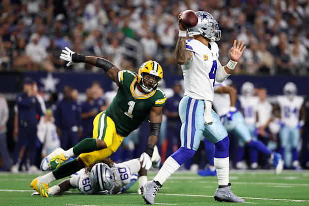 Dallas Cowboys quarterback Dak Prescott throws under pressure from Green Bay Packers defensive end Micah Parsons,