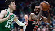 Jan 29, 2025; Boston, Massachusetts, USA; Chicago Bulls guard Coby White (0) controls the ball while Boston Celtics forward Drew Peterson (13) defends during the second half at TD Garden. Mandatory Credit: Bob DeChiara-Imagn Images