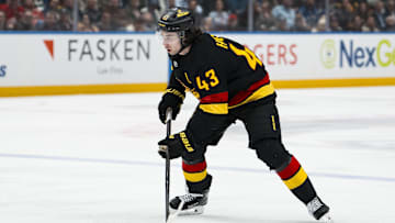 Dec 8, 2025; Vancouver, British Columbia, CAN; Vancouver Canucks defenseman Quinn Hughes (43) handles the puck against the Detroit Red Wings in the second period at Rogers Arena. Mandatory Credit: Bob Frid-Imagn Images
