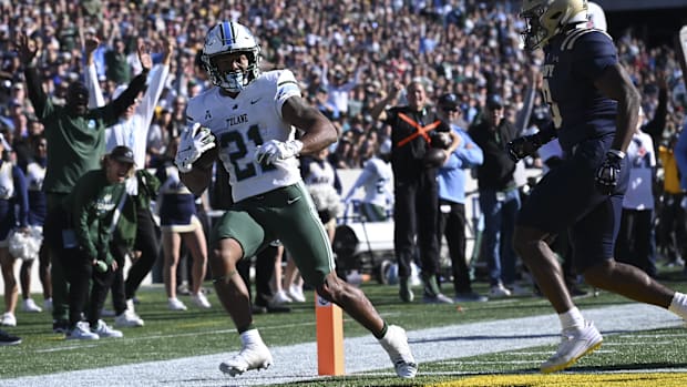Nov 16, 2024; Annapolis, Maryland, USA; Tulane Green Wave running back Makhi Hughes (21) scores in front of Navy Midshipmen s