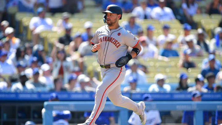 Jul 25, 2024; Los Angeles, California, USA; San Francisco Giants outfielder Michael Conforto (8) scores a run against the Los Angeles Dodgers during the eighth inning at Dodger Stadium.