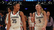 Dec 7, 2024; Brooklyn, New York, USA; Connecticut Huskies guard Azzi Fudd (35) and Connecticut Huskies guard Paige Bueckers (5) celebrate after the game against the Louisville Cardinals at Barclays Center. Mandatory Credit: Lucas Boland-Imagn Images