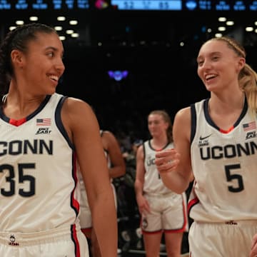 Dec 7, 2024; Brooklyn, New York, USA; Connecticut Huskies guard Azzi Fudd (35) and Connecticut Huskies guard Paige Bueckers (5) celebrate after the game against the Louisville Cardinals at Barclays Center. Mandatory Credit: Lucas Boland-Imagn Images