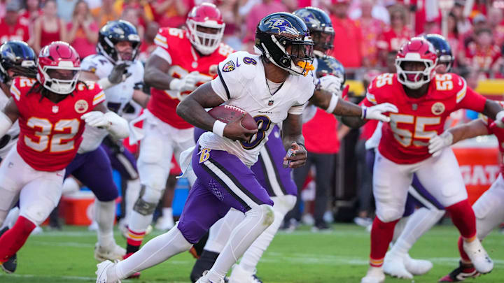 Sep 28, 2025; Kansas City, Missouri, USA; Baltimore Ravens quarterback Lamar Jackson (8) runs the ball as Kansas City Chiefs linebacker Nick Bolton (32) chases during the game at GEHA Field at Arrowhead Stadium. Mandatory Credit: Denny Medley-Imagn Images
