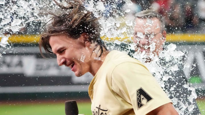 Arizona Diamondbacks outfielder Jake McCarthy (31) is doused with water after hitting a two RBI walk off single against the Colorado Rockies during the ninth inning at Chase Field on Aug 13.