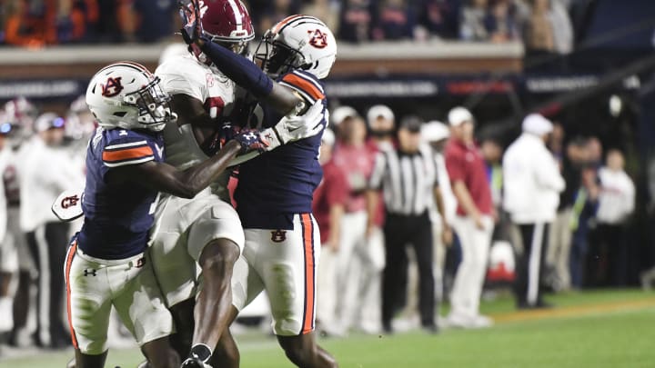 Nov 25, 2023; Auburn, Alabama, USA;  Auburn Tigers cornerback Nehemiah Pritchett (1) and safety Zion Puckett (10) battle for a pass intended for Alabama Crimson Tide tight end Amari Niblack (84) at Jordan-Hare Stadium. Alabama won 27-24. Mandatory Credit: Gary Cosby Jr.-USA TODAY Sports