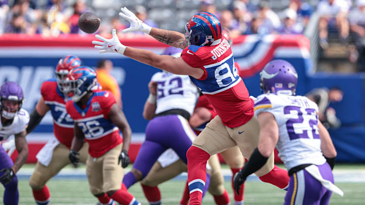 Sep 8, 2024; East Rutherford, New Jersey, USA; New York Giants tight end Theo Johnson (84) makes a catch during the second half in front of Minnesota Vikings safety Harrison Smith (22) at MetLife Stadium.  