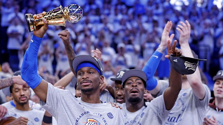 Oklahoma City Thunder guard Shai Gilgeous-Alexander (2) celebrates with Magic Johnson West Conference Finals MVP trophy after defeating the Minnesota Timberwolves.