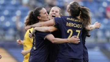 Jul 19, 2024; Seattle, WA, USA; Seattle Reign FC midfielder Olivia Athens (12) celebrates with teammates after scoring on a penalty kick during the first half against the Utah Royals FC at Lumen Field. Mandatory Credit: Stephen Brashear-USA TODAY Sports