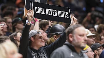Feb 8, 2025; Morgantown, West Virginia, USA; A West Virginia Mountaineers student holds up a sign on Coal Rush night during the second half against the Utah Utes at WVU Coliseum. Mandatory Credit: Ben Queen-Imagn Images