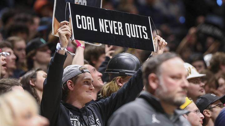 Feb 8, 2025; Morgantown, West Virginia, USA; A West Virginia Mountaineers student holds up a sign on Coal Rush night during the second half against the Utah Utes at WVU Coliseum. Mandatory Credit: Ben Queen-Imagn Images
