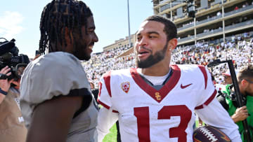 Sep 30, 2023; Boulder, Colorado, USA;  Colorado Buffaloes quarterback Shedeur Sanders (2) meets with