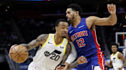 Dec 19, 2024; Detroit, Michigan, USA;  Utah Jazz forward John Collins (20) dribbles on Detroit Pistons forward Tobias Harris (12) in the fourth quarter at Little Caesars Arena. Mandatory Credit: Rick Osentoski-Imagn Images