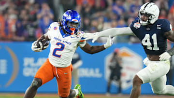 Boise State Broncos running back Ashton Jeanty (2) runs past Penn State Nittany Lions linebacker Kobe King (41) during their Vrbo Fiesta Bowl matchup at State Farm Stadium on Dec. 31, 2024.