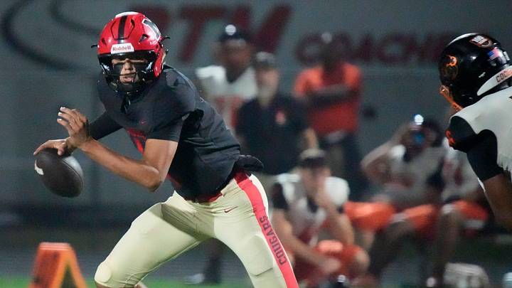 Mooney quarterback Davin Davidson (#4) scrambles as he looks for an open receiver. Cardinal Mooney Catholic High School hosted Cocoa High School for the Class 2A state semi-final football game Friday evening, Dec. 5, 2025. Mooney won the game 40-0.