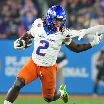 Boise State Broncos running back Ashton Jeanty (2) runs past Penn State Nittany Lions linebacker Kobe King (41) during their Vrbo Fiesta Bowl matchup at State Farm Stadium on Dec. 31, 2024.